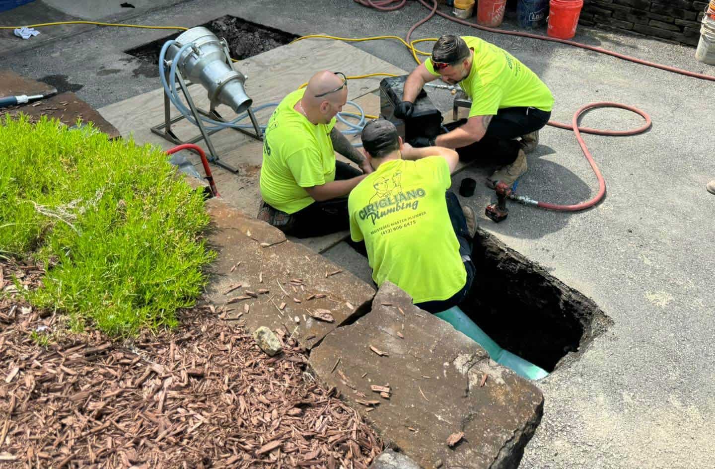Cirigliano crew members working on a sewer line job in neon safety shirts