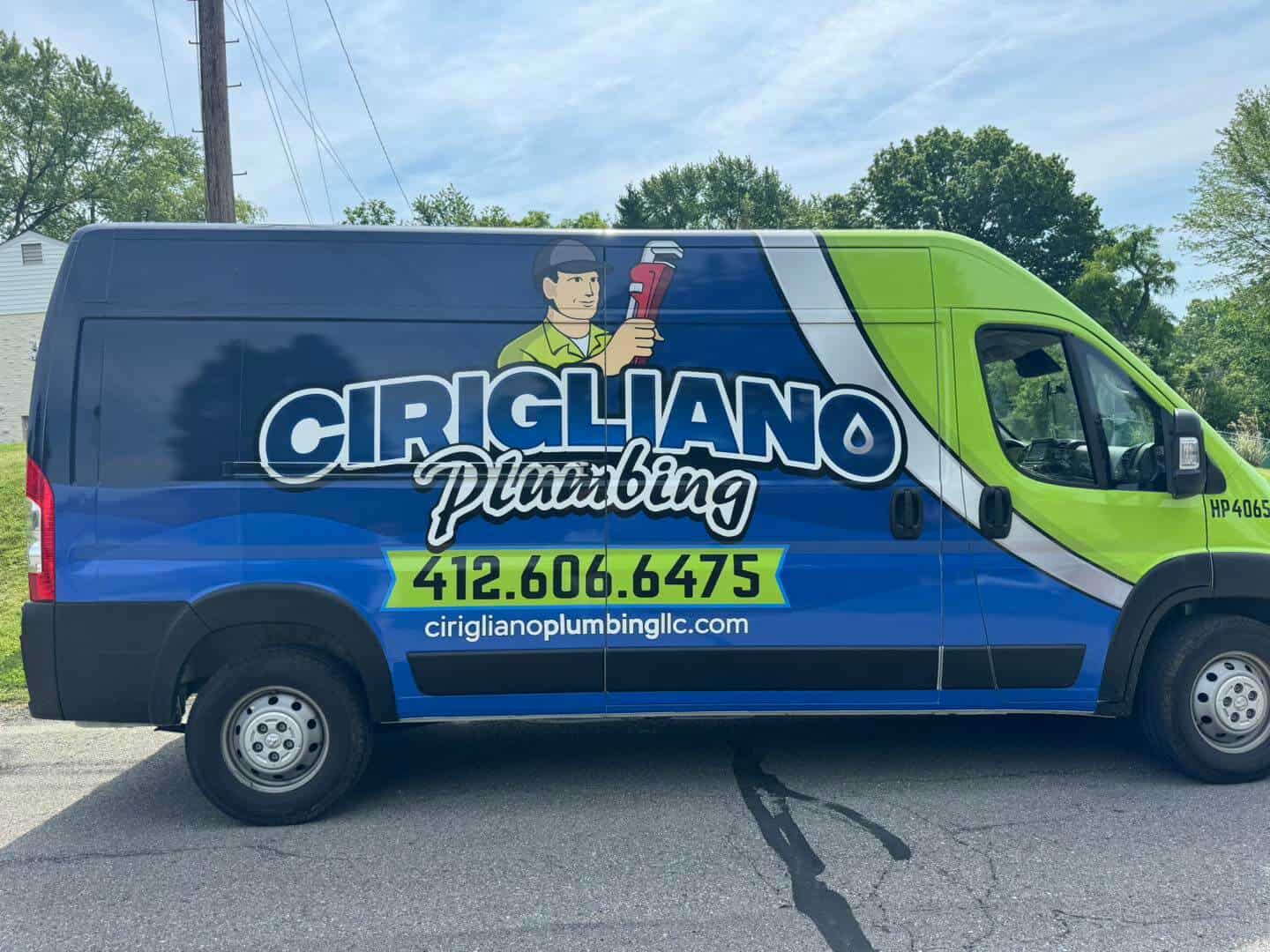 Cirigliano Plumbing branded Ram ProMaster van with navy and lime green wrap